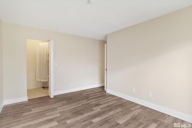 unfurnished room featuring wood-type flooring