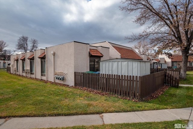 view of property exterior featuring a lawn