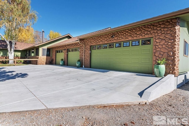 ranch-style house featuring a garage