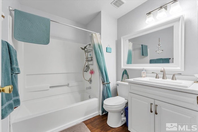 full bathroom with shower / bath combo with shower curtain, vanity, wood-type flooring, and toilet