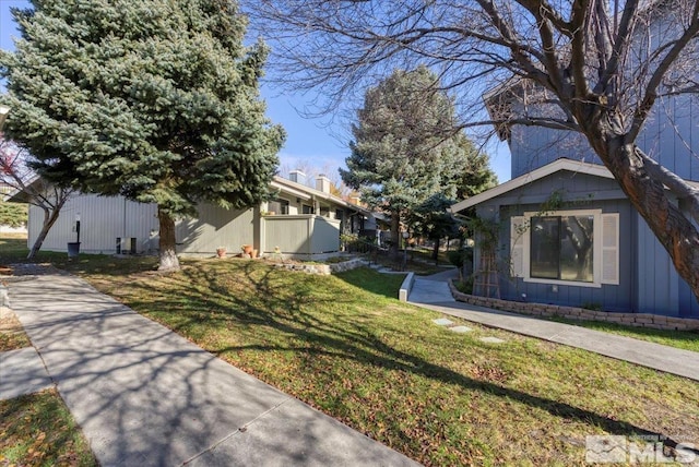 view of side of property with a lawn