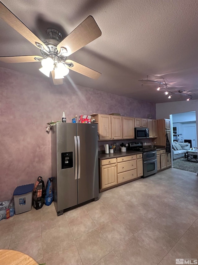 kitchen featuring ceiling fan, light brown cabinetry, stainless steel appliances, and a textured ceiling