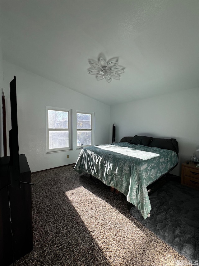 bedroom with carpet flooring, ceiling fan, and lofted ceiling