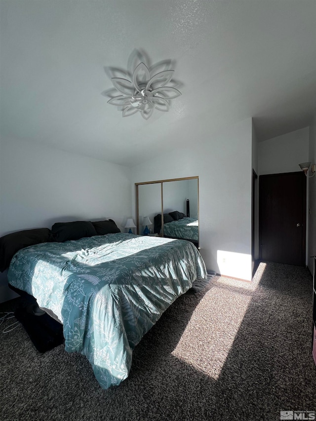 bedroom with carpet flooring, a closet, and a textured ceiling