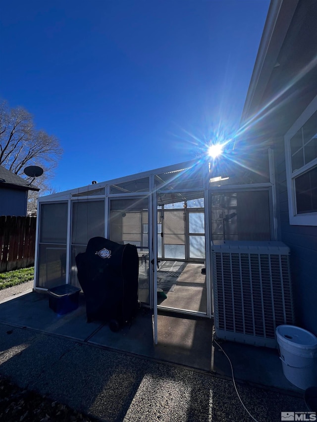 view of patio / terrace with central AC, grilling area, and a lanai