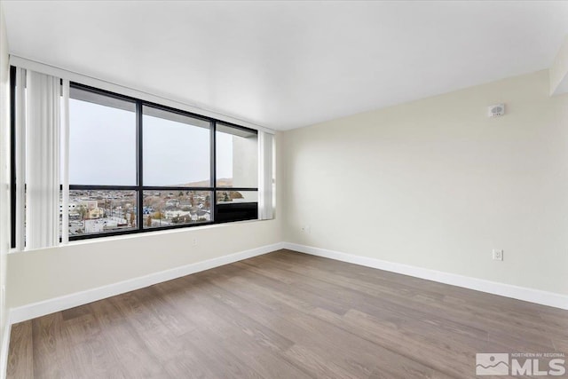 spare room featuring hardwood / wood-style flooring