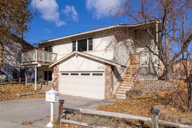 view of front facade with a garage and a balcony