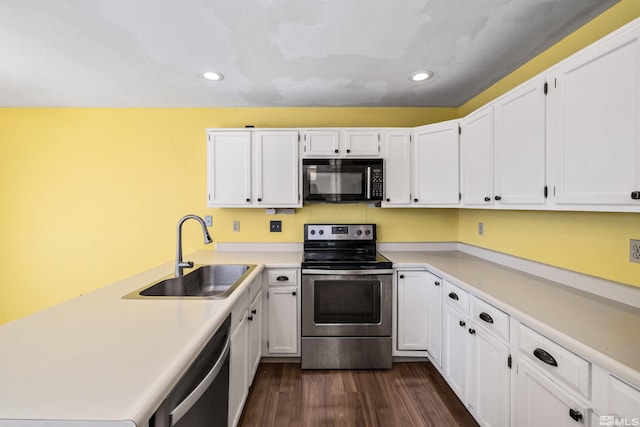 kitchen with white cabinets, dark hardwood / wood-style floors, sink, and appliances with stainless steel finishes