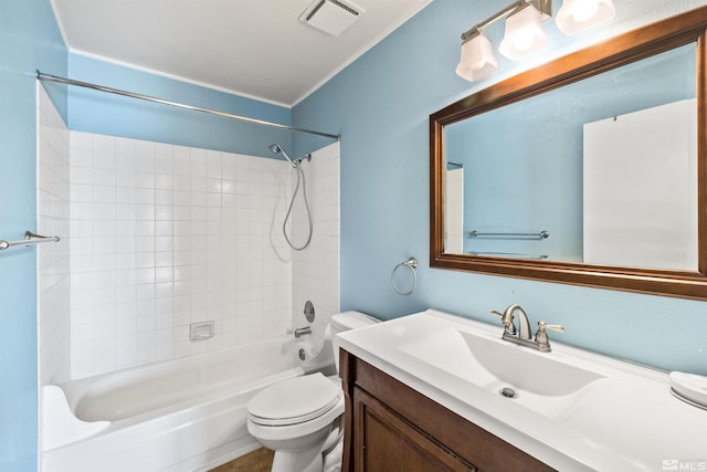 full bathroom featuring tiled shower / bath combo, toilet, and vanity