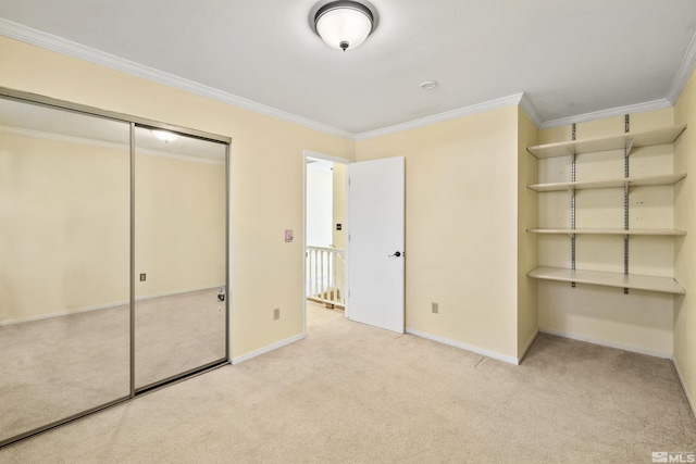 unfurnished bedroom featuring ornamental molding, light carpet, and a closet