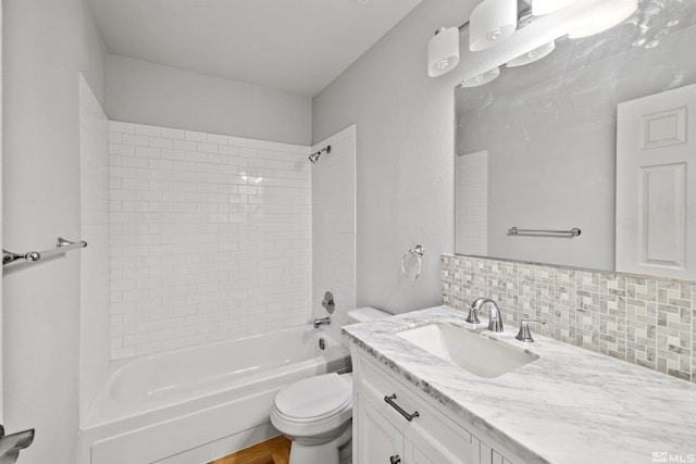 full bathroom with tiled shower / bath combo, toilet, backsplash, and vanity