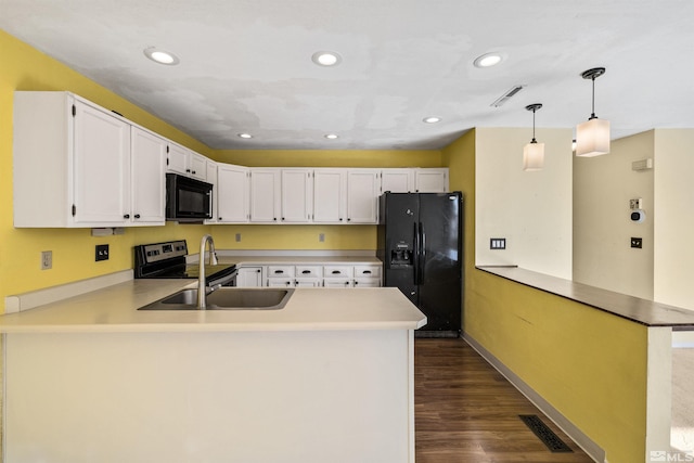 kitchen featuring kitchen peninsula, decorative light fixtures, white cabinetry, and black appliances