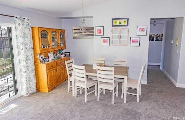 dining area featuring light colored carpet