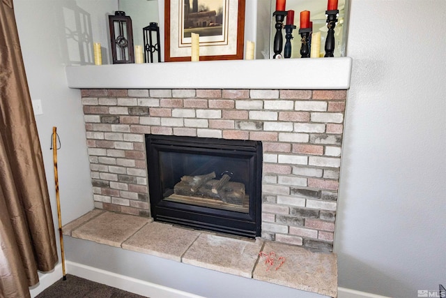 interior details with a brick fireplace