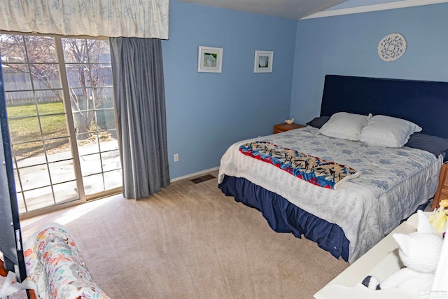 bedroom with carpet floors, access to outside, and multiple windows