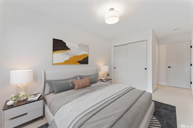 bedroom with light carpet and a closet