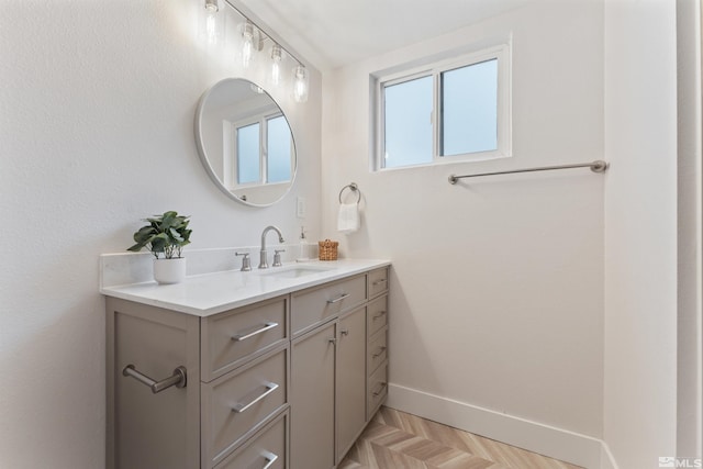 bathroom featuring parquet floors and vanity