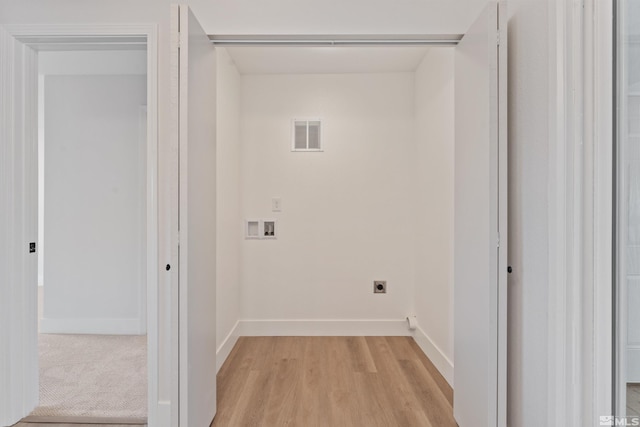 laundry room with electric dryer hookup, washer hookup, and light wood-type flooring