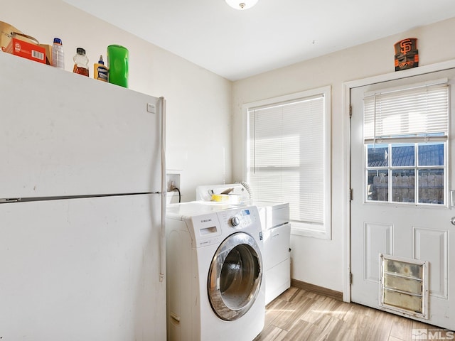 washroom with washer hookup and light hardwood / wood-style flooring