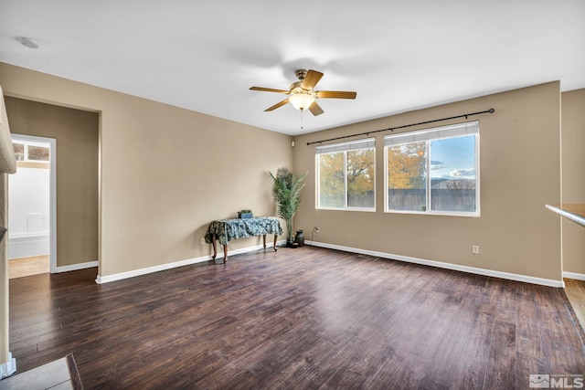 unfurnished room with dark hardwood / wood-style floors and ceiling fan