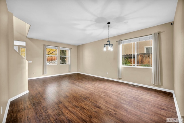 interior space with dark hardwood / wood-style flooring and a chandelier