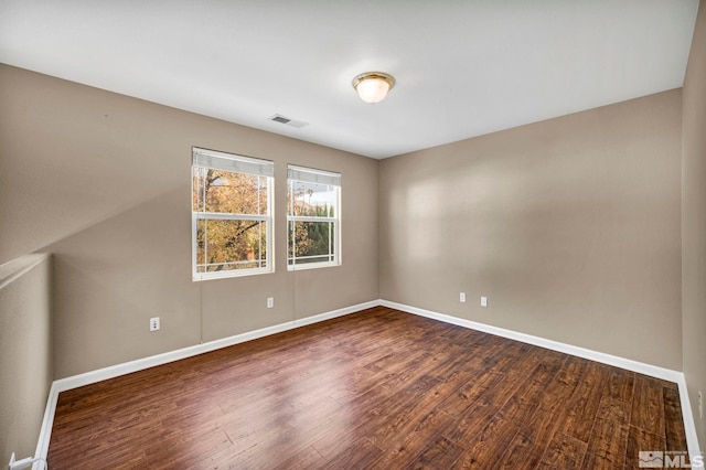 unfurnished room with dark hardwood / wood-style floors