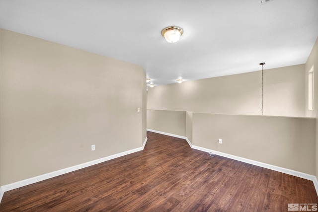 spare room featuring dark wood-type flooring