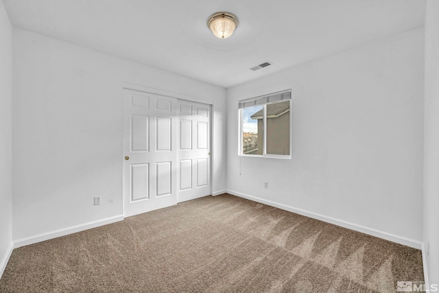 unfurnished bedroom with carpet flooring and a closet