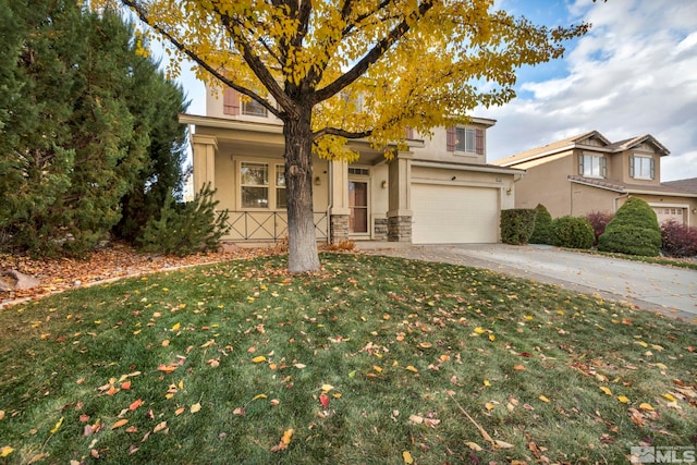 view of front of property with a front yard and a garage