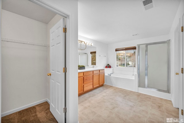 bathroom with vanity and separate shower and tub