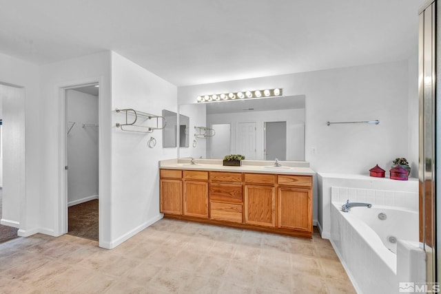 bathroom featuring vanity and tiled bath