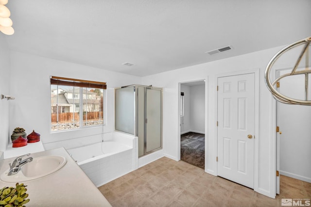 bathroom featuring vanity and independent shower and bath