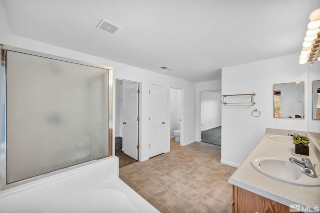 full bathroom featuring vanity, shower with separate bathtub, and toilet