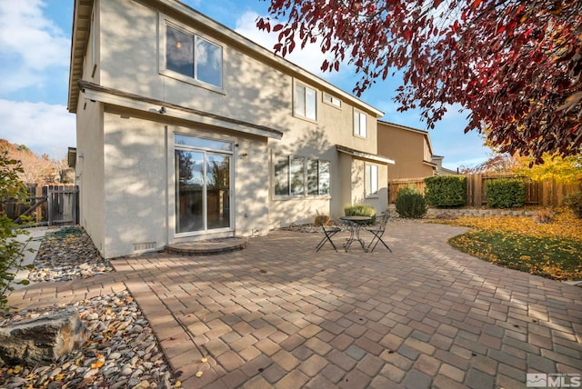 back of property with a patio area