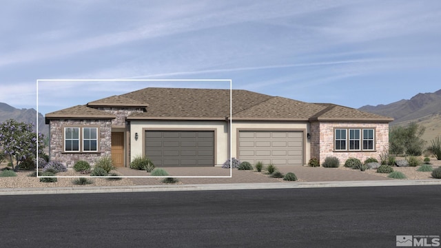 view of front facade featuring a mountain view and a garage