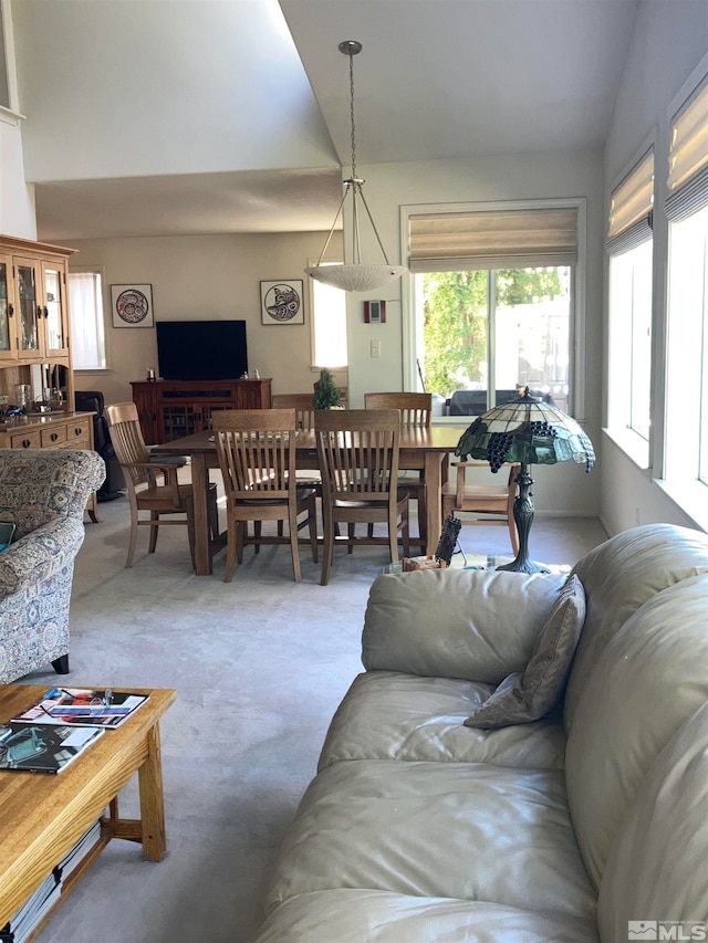 living room featuring light colored carpet and vaulted ceiling