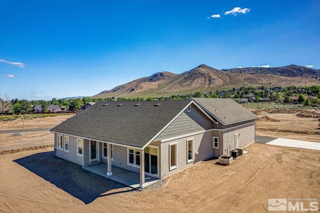 exterior space with a mountain view, cooling unit, and a patio