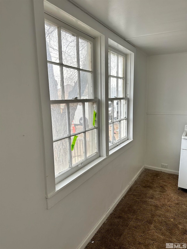unfurnished room featuring carpet and plenty of natural light