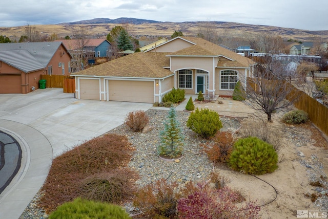 single story home with a mountain view and a garage