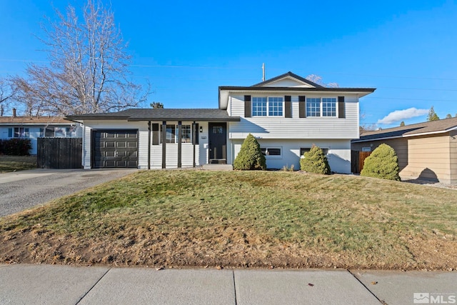 tri-level home featuring a garage and a front yard