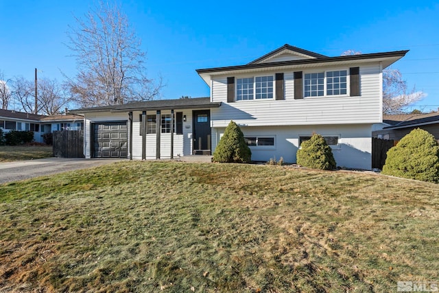 split level home featuring a front lawn and a garage