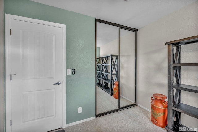 bedroom featuring a closet and light colored carpet