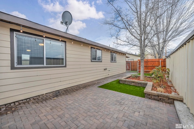 view of side of property with a patio area