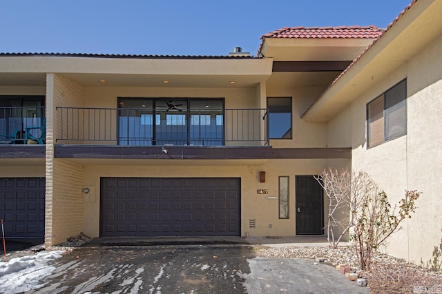 view of front of property featuring a garage and a balcony