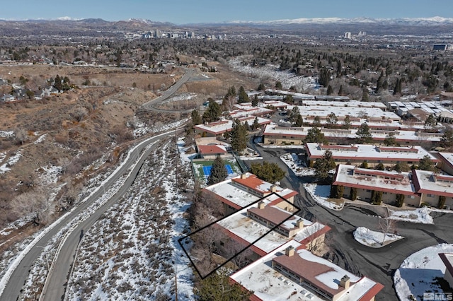 snowy aerial view with a mountain view