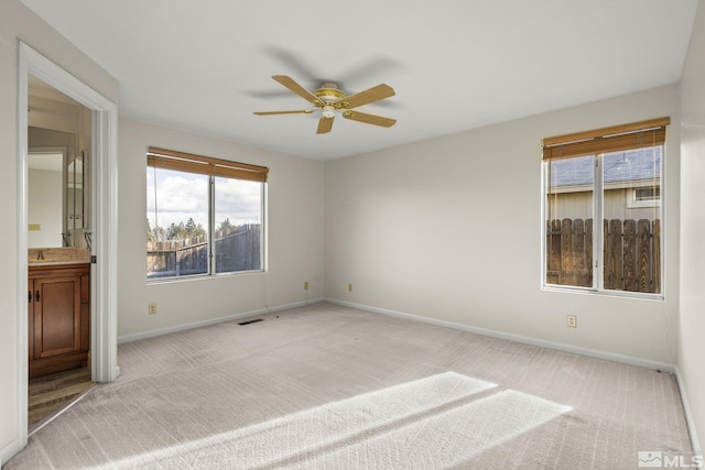 carpeted empty room with ceiling fan