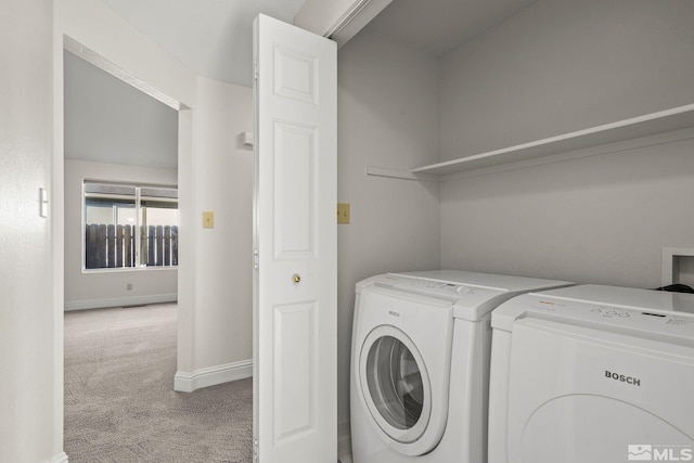 laundry room with light colored carpet and washer and clothes dryer