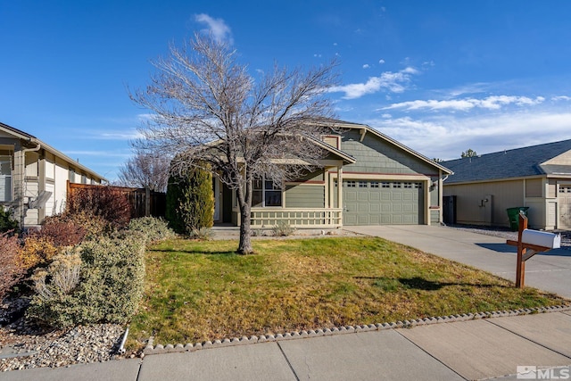 view of front of property featuring a porch, a garage, and a front lawn