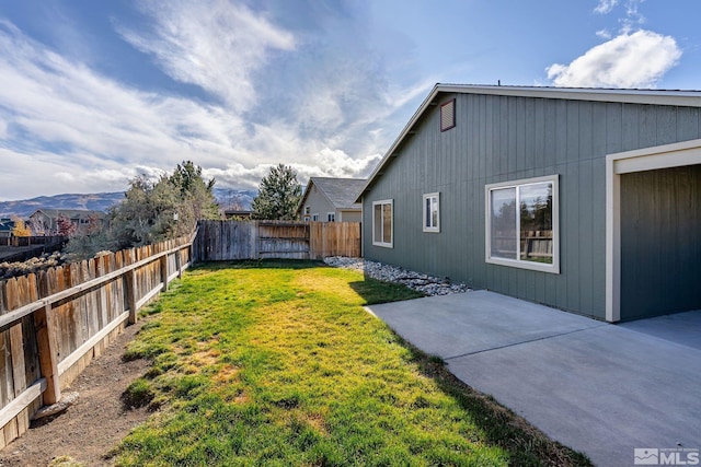 view of yard featuring a mountain view and a patio area