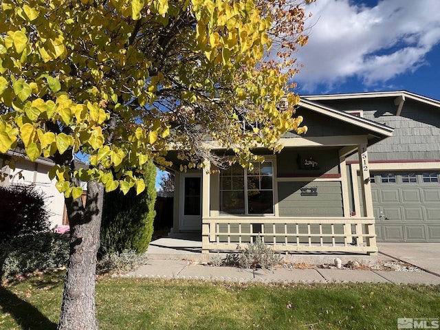 view of front of home featuring a porch and a garage